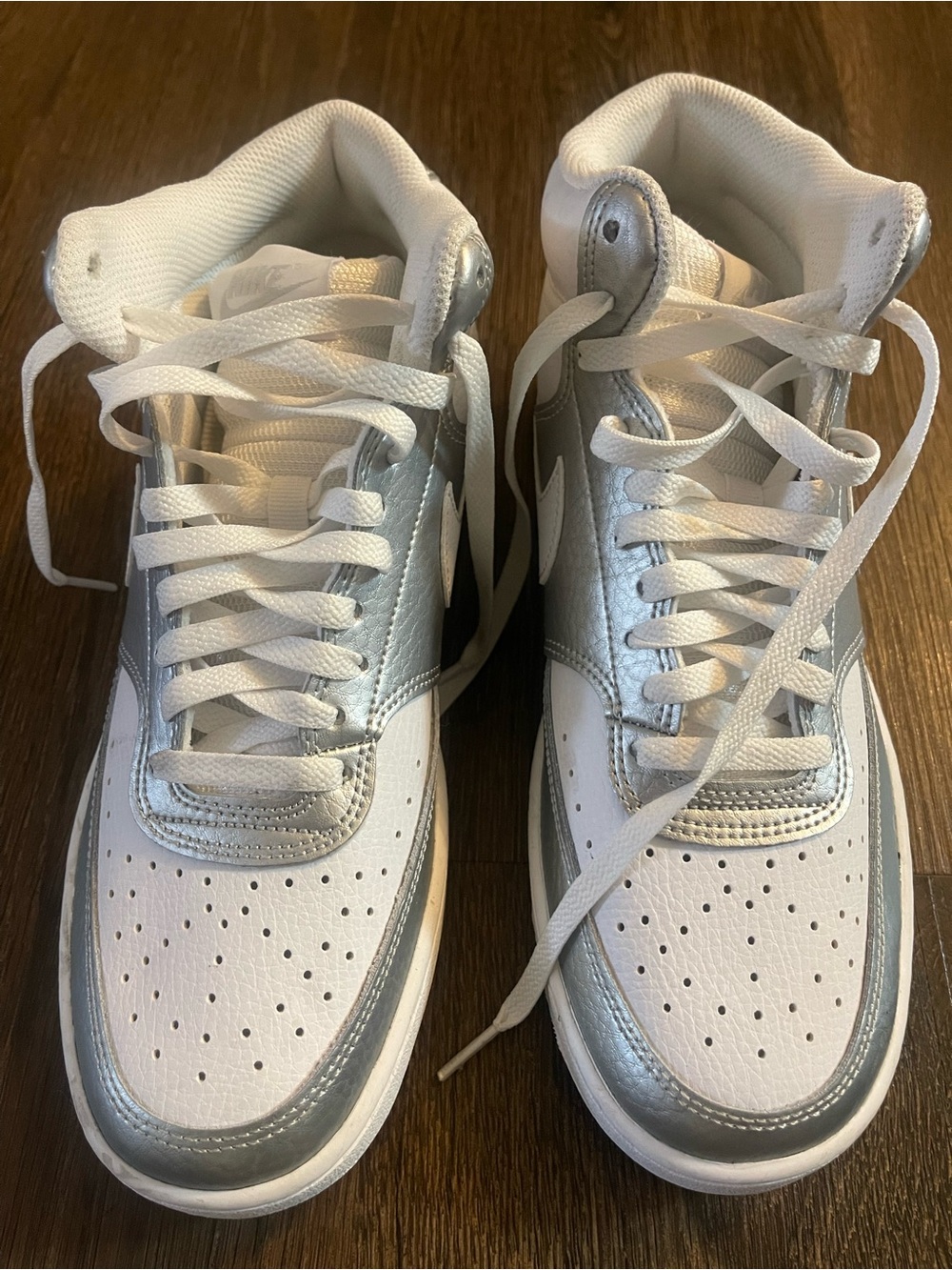 Nike Court Vision Mid features a white and metallic silver leather upper Size 9